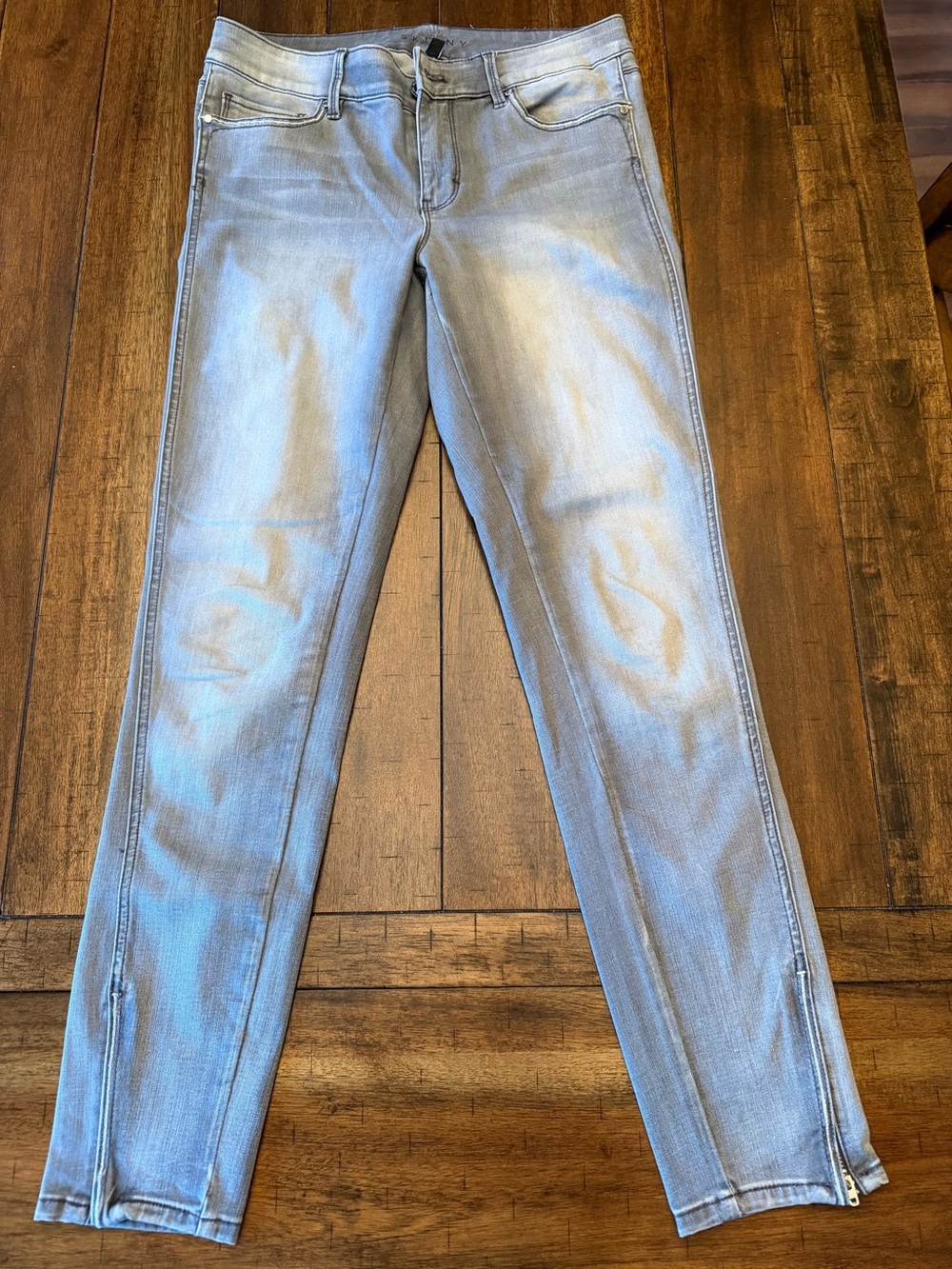 Grey faded jeans with ankle zippers